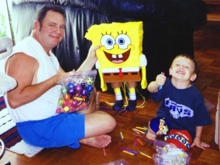 Helping Dad fill the pinata for my fourth birthday