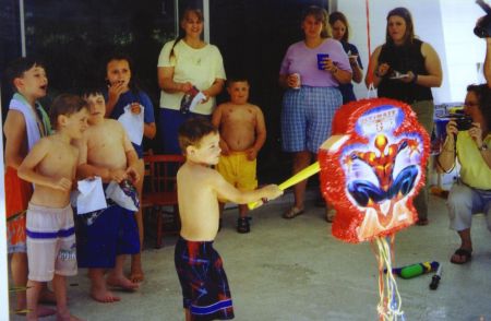 Trying the break the Spider-man pinata at my fifth birthday party!
