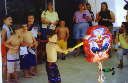 Trying the break the Spider-man pinata at my fifth birthday party!